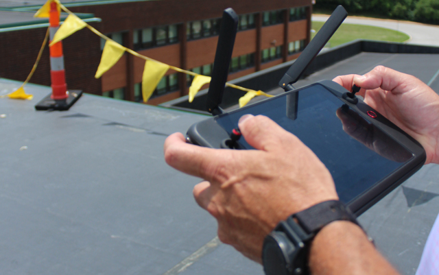 Ryan O’Connell, President of RMT Roofing and Waterproofing Consultants, performing a drone-assisted roof and building envelope inspection.